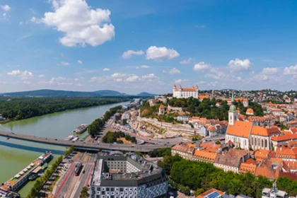 Panoramic view of Bratislava featuring the Danube River, UFO Bridge, and Bratislava Castle
