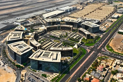 Aerial view of Dubai Airport Freezone buildings beside airport runways and major roadways