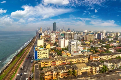 Aerial view of Colombo's city skyline with coastal road, modern high-rises, and the Indian Ocean