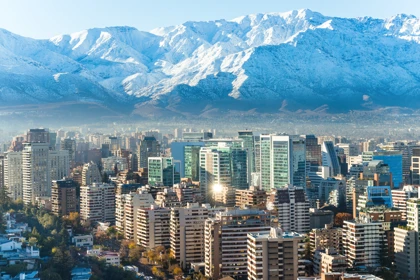 Santiago city skyline with modern high-rise buildings and snow-capped Andes mountains in the background