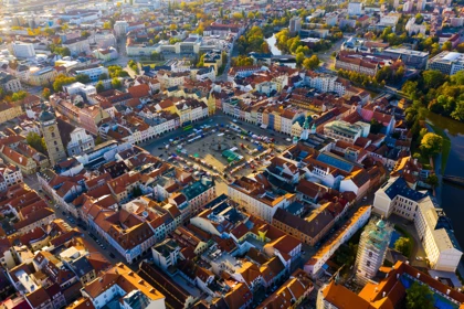 Aerial view of České Budějovice's historic town square, surrounded by colorful buildings and red-tiled rooftops