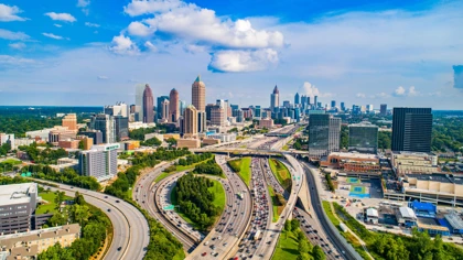 Atlanta skyline with modern skyscrapers and busy highways under a bright blue sky