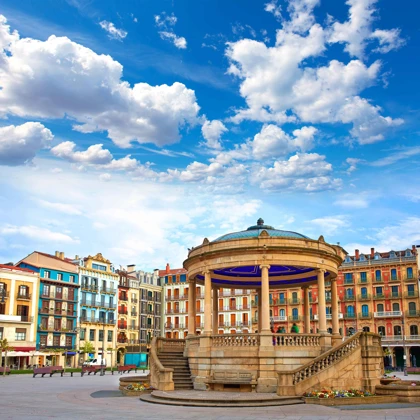Scenic view of Plaza del Castillo in Pamplona, Spain, featuring the central gazebo and colorful surrounding buildings