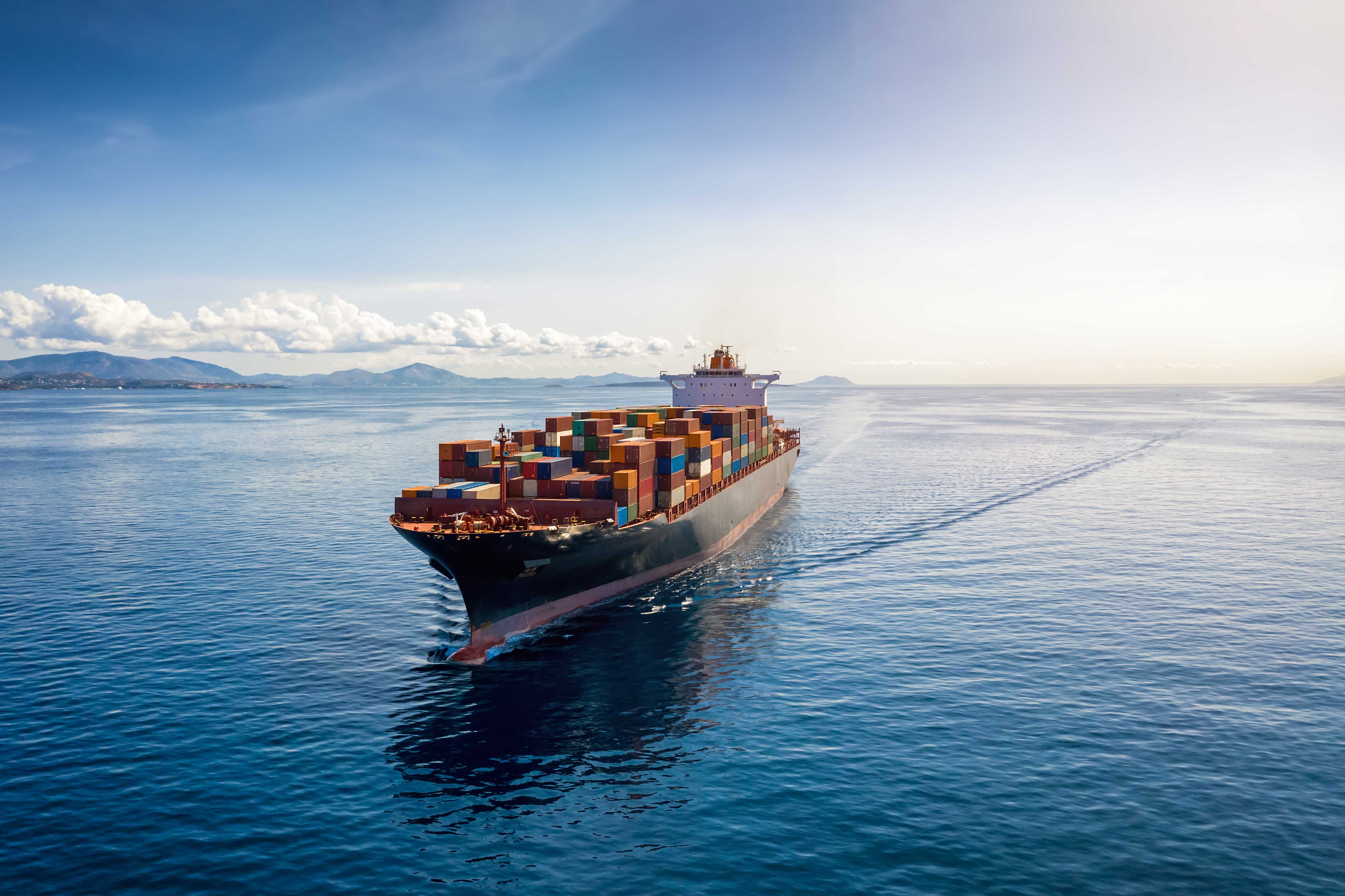 cargo-ship-sailing-near-mountains