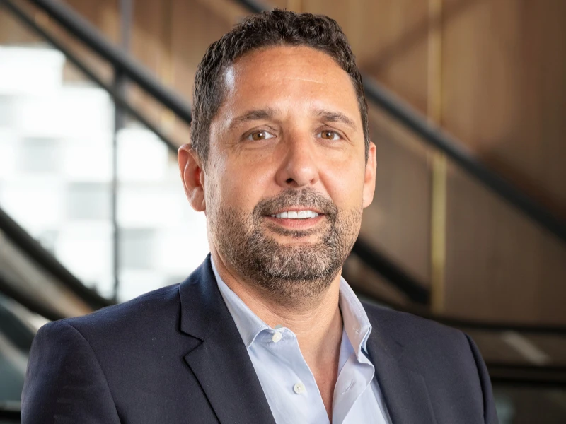 Daniel Cacciotti of Scan Global Logistics in business attire, standing indoors with a confident expression