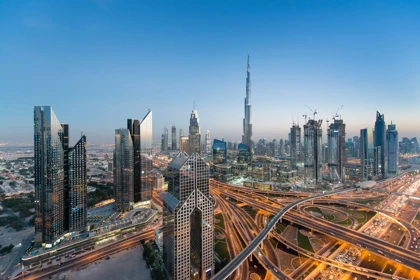 Dubai skyline featuring the Burj Khalifa, illuminated highways, and modern skyscrapers at dusk