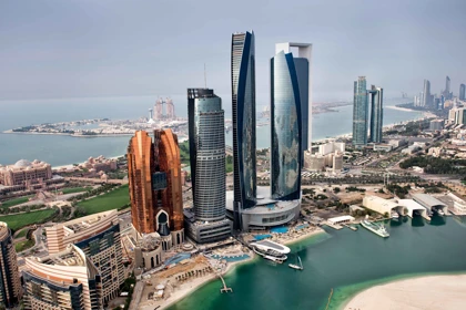 Skyline of Abu Dhabi featuring the Etihad Towers and surrounding modern architecture along the coastline