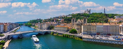 Scenic view of Lyon, France, featuring the Saône River, historic buildings, and Basilica of Notre-Dame de Fourvière