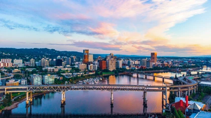 Portland skyline at sunset with bridges spanning the Willamette River