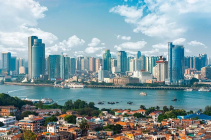 Xiamen skyline with modern skyscrapers, a waterfront view, and traditional architecture in the foreground