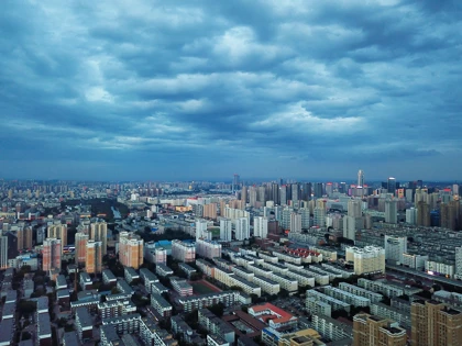 Shenyang city skyline with dense residential and commercial buildings under a cloudy sky
