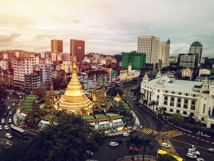 The golden Sule Pagoda surrounded by modern buildings and bustling streets in Yangon, Myanmar