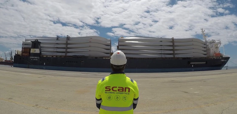  A man looking at the ocean cargo with rotor blades