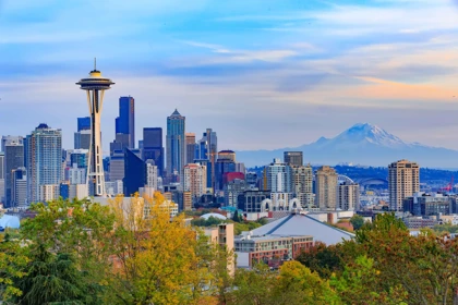 Seattle skyline featuring the Space Needle with Mount Rainier in the background during sunset
