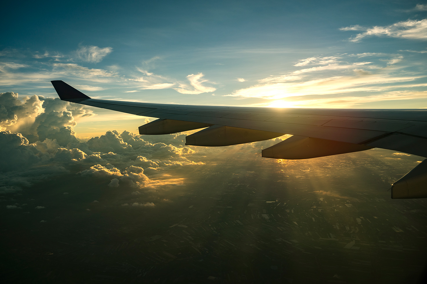 airplane-wing-sunset-clouds-view