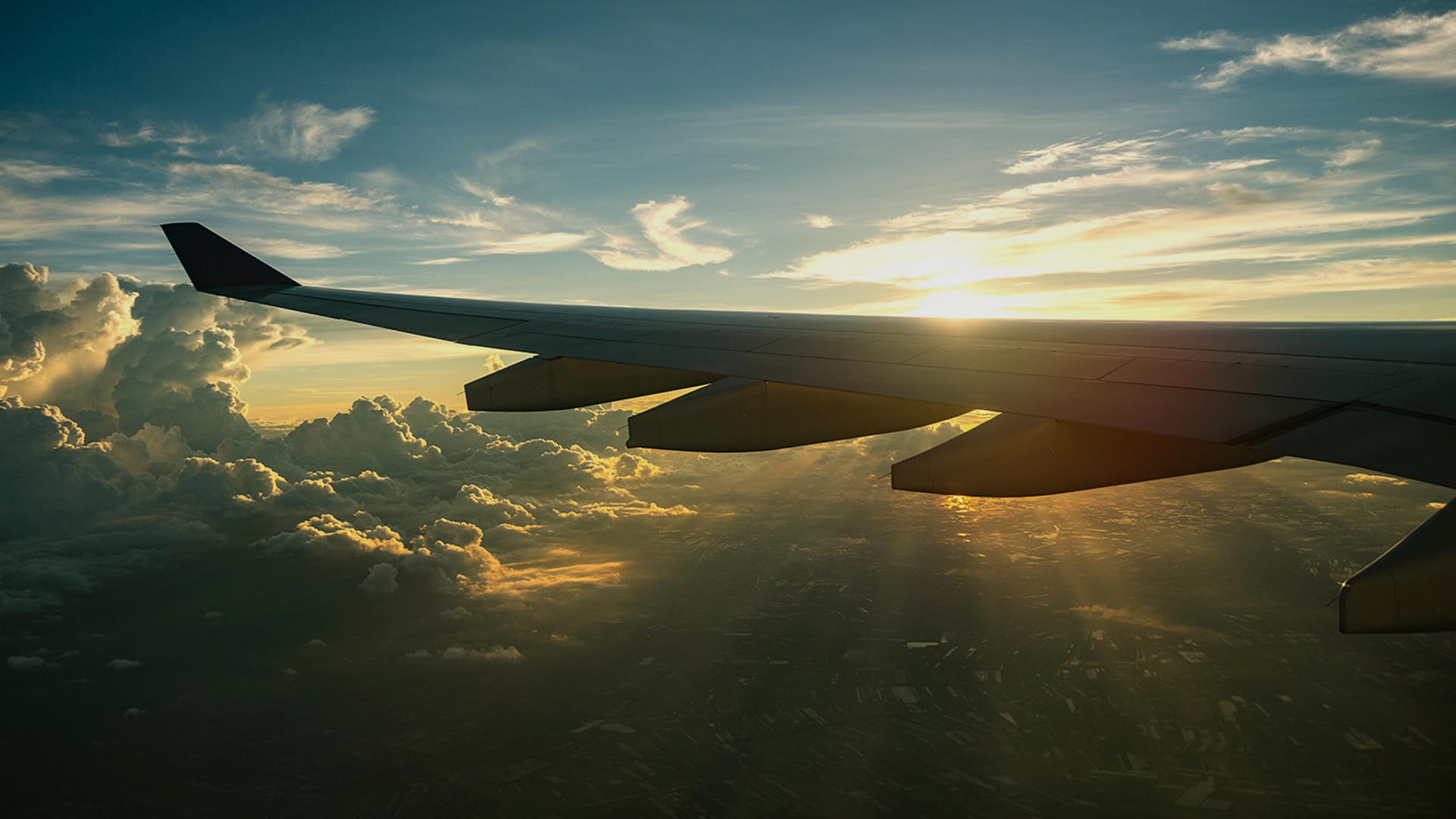airplane-wing-sunset-clouds-view